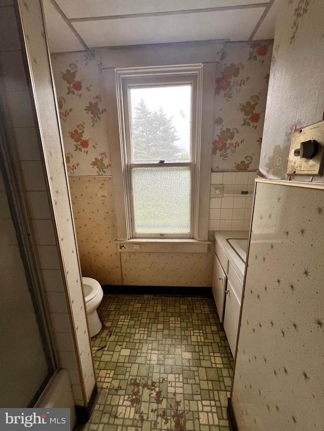 221 S State St, Talmage, PA 17580 - bathroom featuring wallpapered walls, toilet, and wainscoting