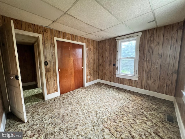 221 S State St, Talmage, PA 17580 - spare room with a paneled ceiling, carpet, wood walls, and baseboards