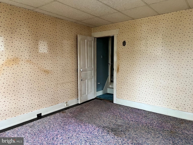 221 S State St, Talmage, PA 17580 - empty room with a paneled ceiling, wallpapered walls, baseboards, and dark carpet
