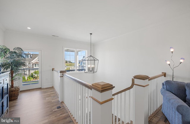 64 Blackpool Rd, Rehoboth Beach, DE 19971 - hall with an upstairs landing, a chandelier, wood finished floors, and ornamental molding