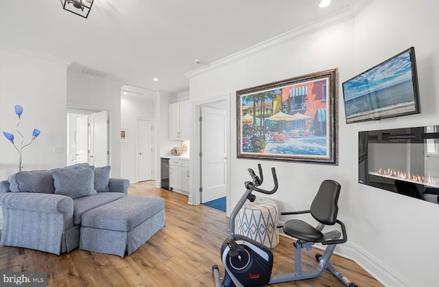 64 Blackpool Rd, Rehoboth Beach, DE 19971 - living room with light wood-type flooring, ornamental molding, baseboards, recessed lighting, and wine cooler