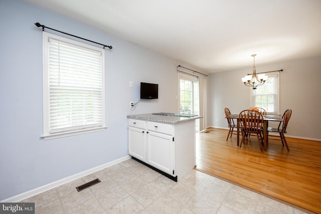 106 Everest Cir Unit 106, West Chester, PA 19382 - kitchen with a chandelier, white cabinetry, decorative light fixtures, and baseboards