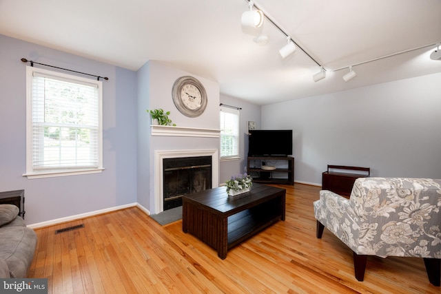106 Everest Cir Unit 106, West Chester, PA 19382 - living room featuring track lighting, light wood-style floors, a glass covered fireplace, and baseboards