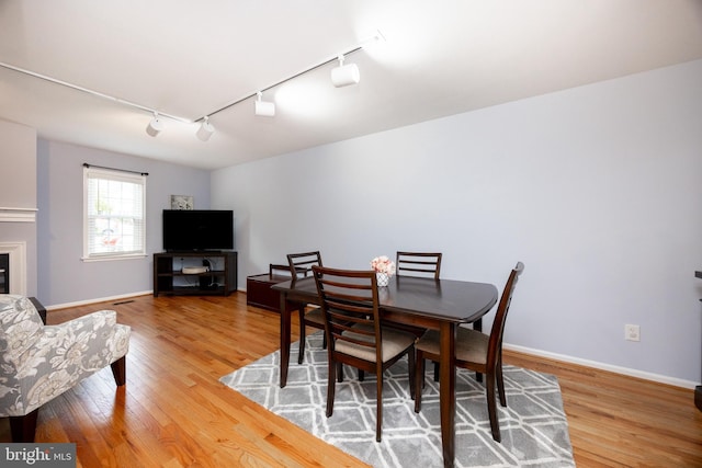106 Everest Cir Unit 106, West Chester, PA 19382 - dining area featuring rail lighting, wood finished floors, and baseboards