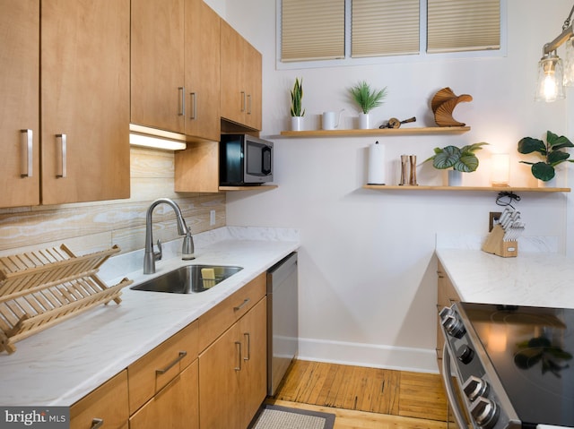 200 Lincoln Ave Unit 213, Phoenixville, PA 19460 - kitchen featuring appliances with stainless steel finishes, open shelves, a sink, baseboards, and backsplash