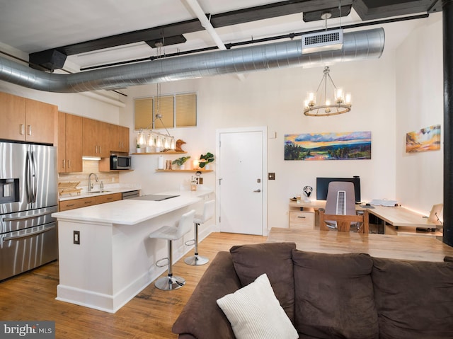 200 Lincoln Ave Unit 213, Phoenixville, PA 19460 - kitchen with appliances with stainless steel finishes, a chandelier, a sink, a breakfast bar area, and light countertops