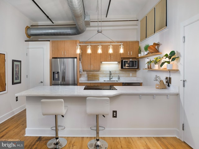 200 Lincoln Ave Unit 213, Phoenixville, PA 19460 - kitchen featuring appliances with stainless steel finishes, a sink, a kitchen bar, and backsplash