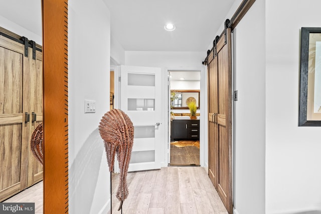 68 Winthrop Rd, Monroe Township, NJ 08831 - corridor featuring a barn door, light wood-style floors, built in shelves, and recessed lighting