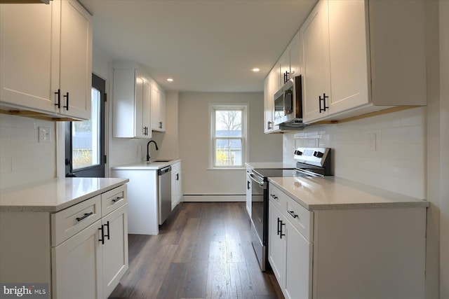 323 Plaza Dr, Palmyra, PA 17078 - kitchen with appliances with stainless steel finishes, a sink, dark wood-type flooring, recessed lighting, and backsplash