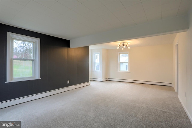323 Plaza Dr, Palmyra, PA 17078 - carpeted empty room with baseboard heating, a chandelier, a baseboard radiator, and wooden walls