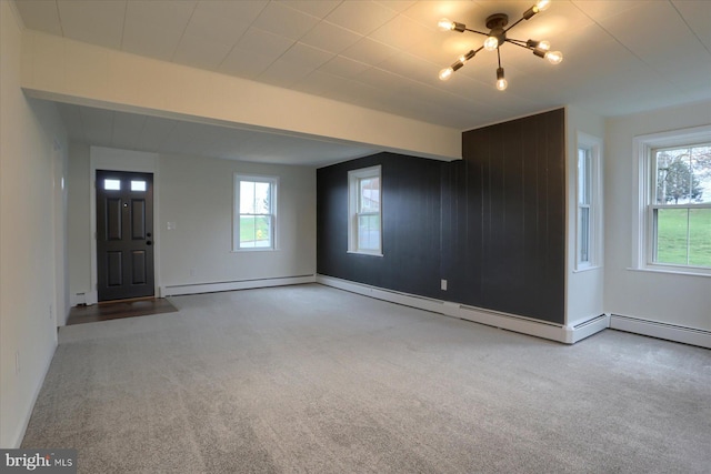 323 Plaza Dr, Palmyra, PA 17078 - unfurnished living room featuring carpet, a chandelier, a baseboard radiator, and baseboards