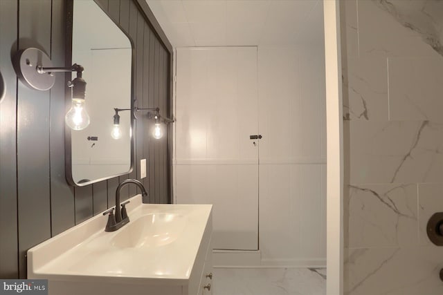 323 Plaza Dr, Palmyra, PA 17078 - bathroom with marble finish flooring, vanity, and a decorative wall
