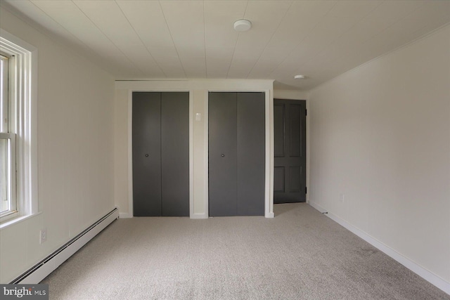 323 Plaza Dr, Palmyra, PA 17078 - unfurnished bedroom featuring a baseboard radiator, multiple closets, and carpet floors