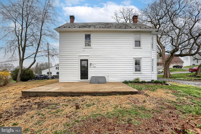323 Plaza Dr, Palmyra, PA 17078 - rear view of house with a chimney and a patio area
