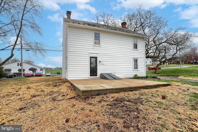 323 Plaza Dr, Palmyra, PA 17078 - rear view of house featuring a chimney and a patio