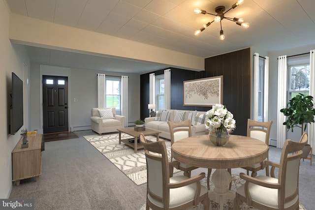 323 Plaza Dr, Palmyra, PA 17078 - dining space with healthy amount of natural light, a baseboard radiator, a chandelier, and light carpet