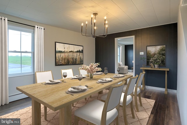 323 Plaza Dr, Palmyra, PA 17078 - dining room featuring a chandelier, wood finished floors, a baseboard heating unit, wood walls, and baseboards