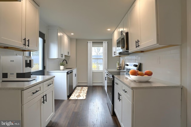 323 Plaza Dr, Palmyra, PA 17078 - kitchen featuring stainless steel appliances, dark wood-style flooring, recessed lighting, light countertops, and a sink