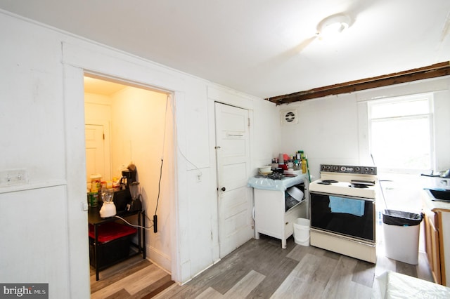 113 Washington St, Cambridge, MD 21613 - kitchen with white range with electric stovetop, light wood-style floors, light countertops, and a sink
