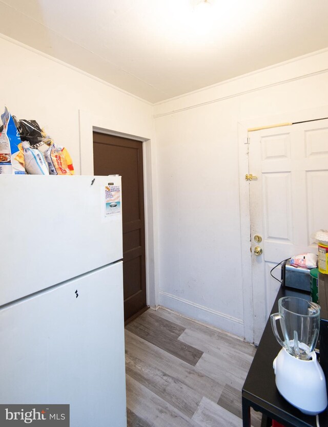 113 Washington St, Cambridge, MD 21613 - kitchen featuring freestanding refrigerator and light wood finished floors