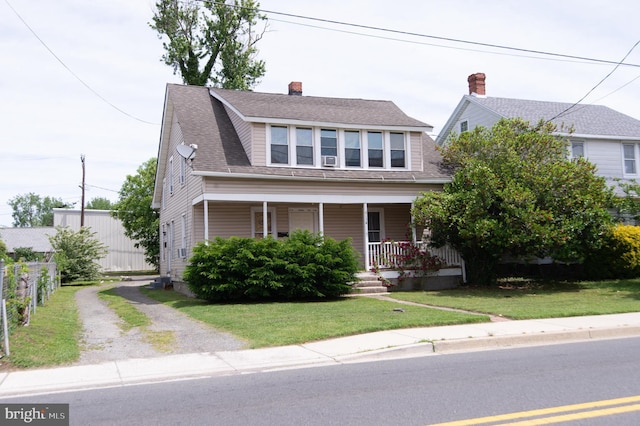 113 Washington St, Cambridge, MD 21613 - bungalow with covered porch, dirt driveway, and a chimney