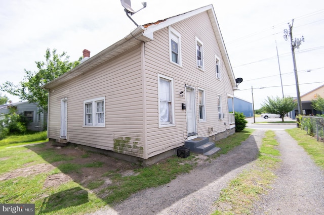 113 Washington St, Cambridge, MD 21613 - view of property exterior with entry steps and a chimney