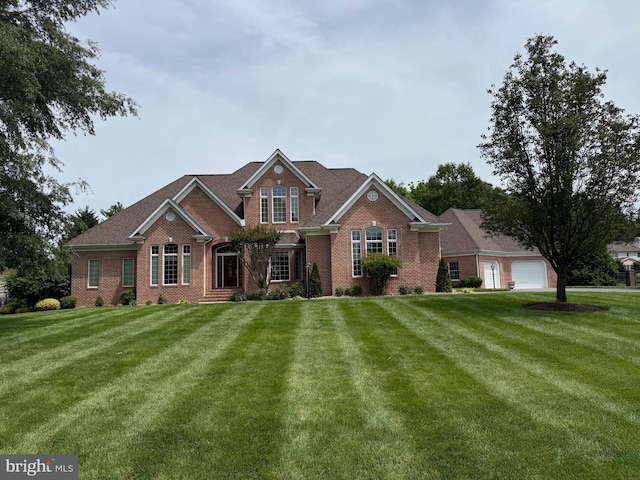 9 Chadwick Dr, Dover, DE 19901 - traditional home with brick siding, a front yard, and a garage