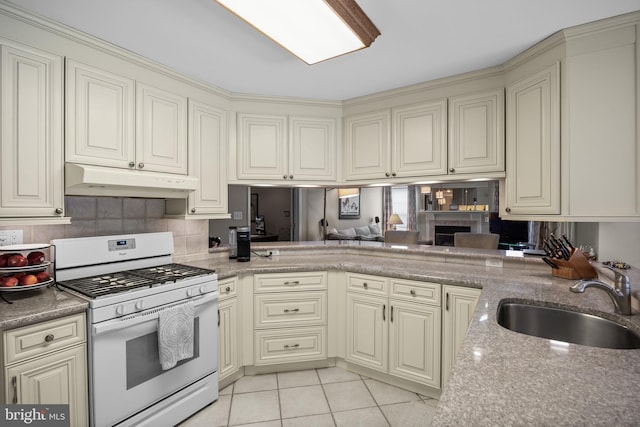 29 Dominion Dr, Marlton, NJ 08053 - kitchen with white range with gas stovetop, a sink, under cabinet range hood, and cream cabinets