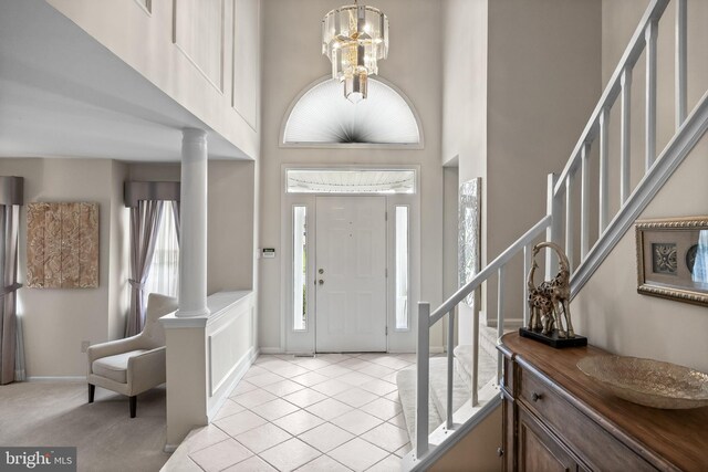 29 Dominion Dr, Marlton, NJ 08053 - entryway with stairway, a towering ceiling, decorative columns, light tile patterned flooring, and a chandelier