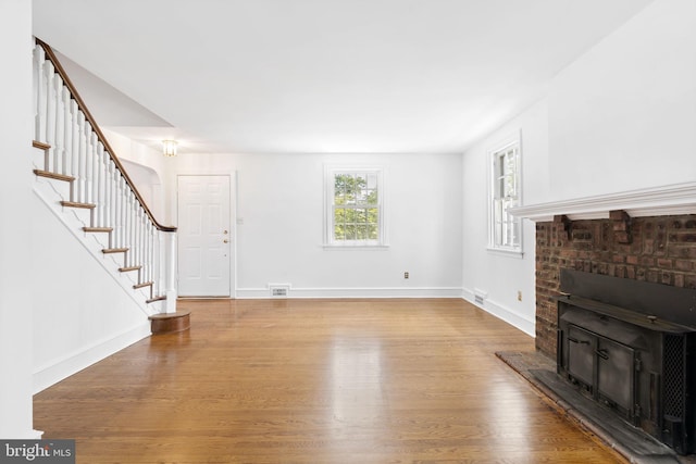 534 Hillcrest Ave, Glenside, PA 19038 - unfurnished living room featuring stairs, wood finished floors, baseboards, and a fireplace