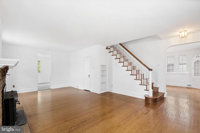 534 Hillcrest Ave, Glenside, PA 19038 - unfurnished living room featuring stairs, wood finished floors, baseboards, and a fireplace