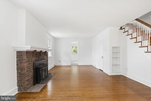 534 Hillcrest Ave, Glenside, PA 19038 - unfurnished living room with wood finished floors, stairs, baseboards, and built in shelves