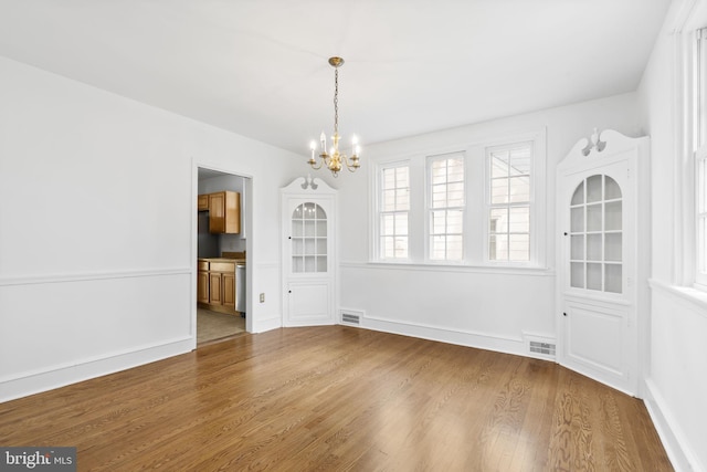 534 Hillcrest Ave, Glenside, PA 19038 - unfurnished dining area with a chandelier, wood finished floors, and baseboards