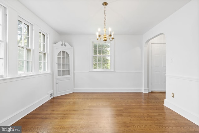 534 Hillcrest Ave, Glenside, PA 19038 - unfurnished dining area featuring a chandelier, wood finished floors, baseboards, and arched walkways