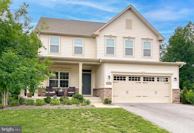 8716 Windon Ct, Waldorf, MD 20603 - view of front of home featuring a garage, driveway, a front lawn, a porch, and stone siding