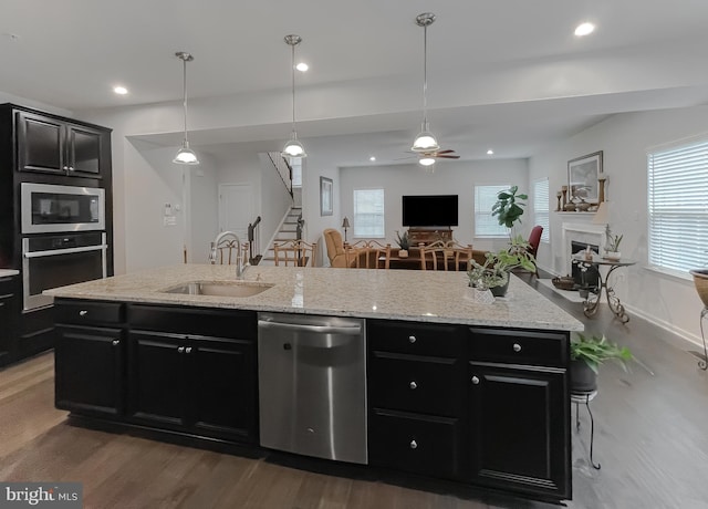8716 Windon Ct, Waldorf, MD 20603 - kitchen featuring appliances with stainless steel finishes, dark cabinetry, a sink, wood finished floors, and open floor plan