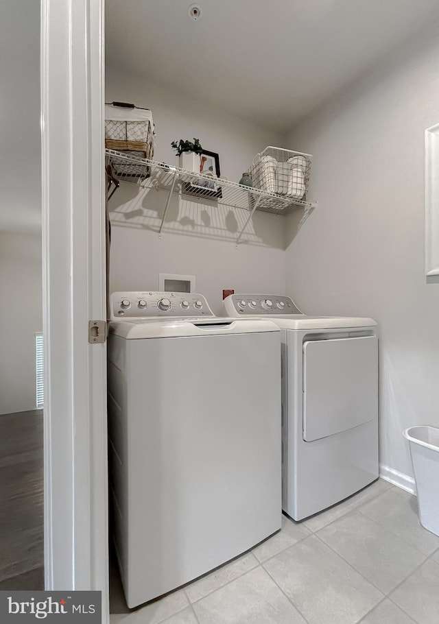 8716 Windon Ct, Waldorf, MD 20603 - laundry room featuring washing machine and dryer and light tile patterned flooring