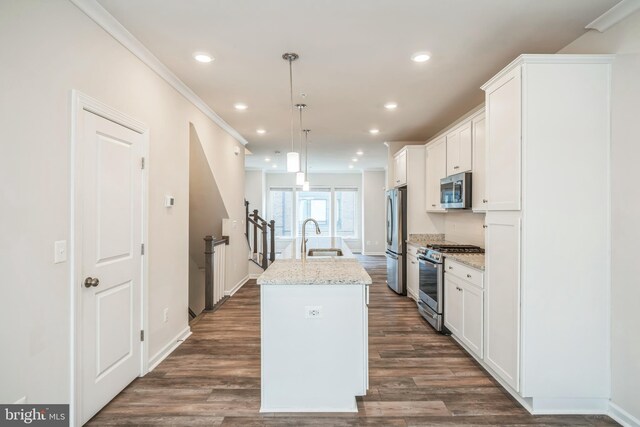 8039 Baxter St, Derwood, MD 20855 - kitchen with stainless steel appliances, a kitchen island with sink, white cabinetry, recessed lighting, and light stone counters