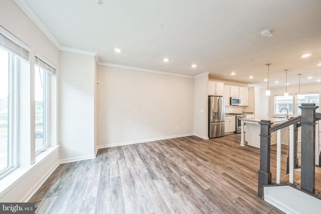 8039 Baxter St, Derwood, MD 20855 - unfurnished living room featuring wood finished floors, crown molding, recessed lighting, baseboards, and a sink