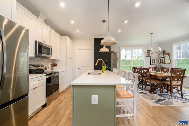 3707 Thicket Run Pl, Charlottesville, VA 22911 - kitchen featuring appliances with stainless steel finishes, a sink, ornamental molding, decorative backsplash, and a center island with sink