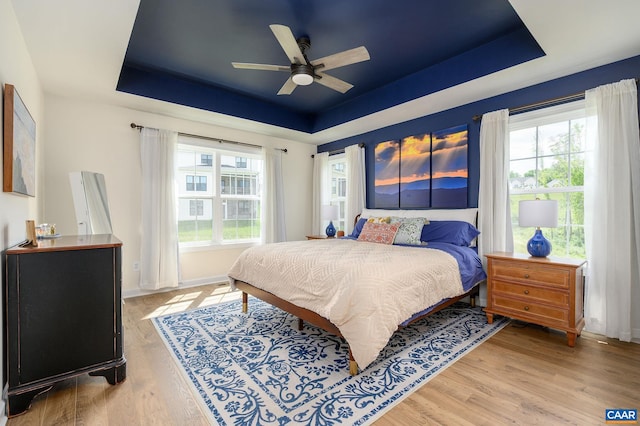 3707 Thicket Run Pl, Charlottesville, VA 22911 - bedroom featuring a raised ceiling, light wood finished floors, baseboards, and a ceiling fan