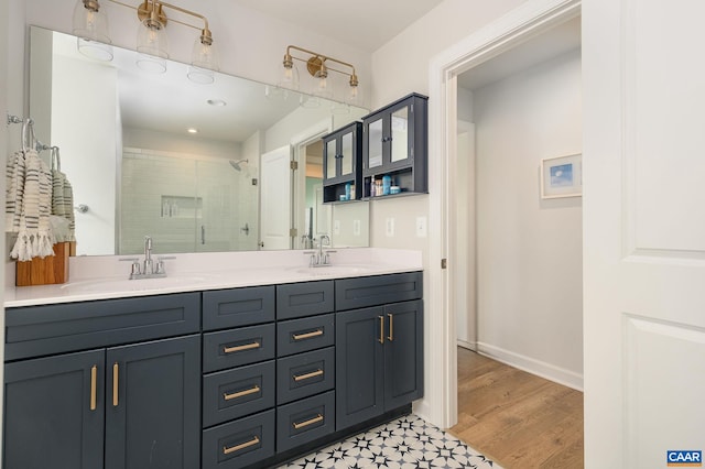 3707 Thicket Run Pl, Charlottesville, VA 22911 - bathroom with a stall shower, double vanity, recessed lighting, baseboards, and wood finished floors