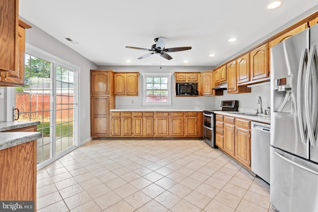 95 Twin Oak Dr, Levittown, PA 19056 - kitchen with appliances with stainless steel finishes, under cabinet range hood, light countertops, healthy amount of natural light, and recessed lighting