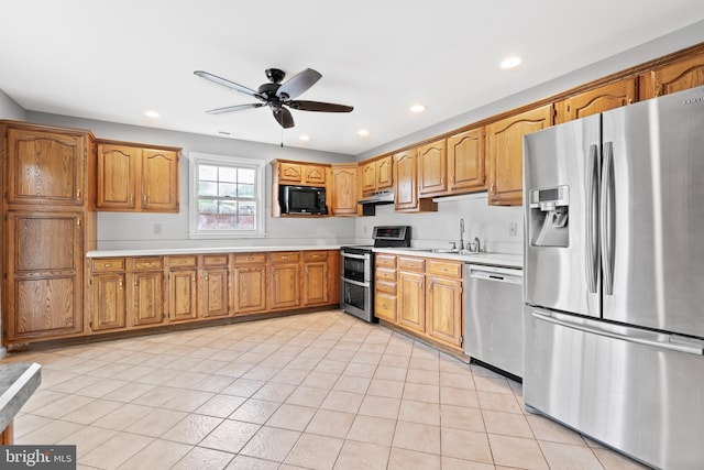 95 Twin Oak Dr, Levittown, PA 19056 - kitchen featuring appliances with stainless steel finishes, under cabinet range hood, ceiling fan, light countertops, and recessed lighting