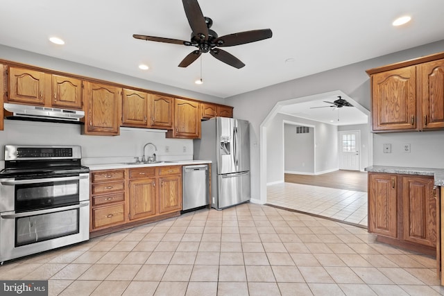 95 Twin Oak Dr, Levittown, PA 19056 - kitchen with under cabinet range hood, appliances with stainless steel finishes, ceiling fan, a sink, and light countertops