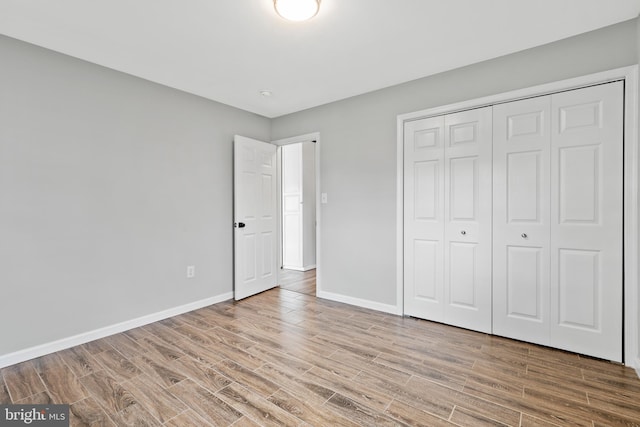 95 Twin Oak Dr, Levittown, PA 19056 - unfurnished bedroom with wood finished floors, baseboards, and a closet