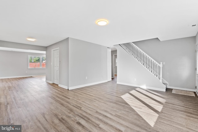 95 Twin Oak Dr, Levittown, PA 19056 - unfurnished living room featuring stairway, baseboards, and wood finished floors