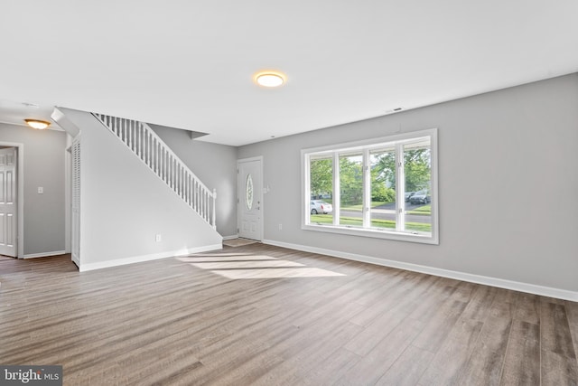 95 Twin Oak Dr, Levittown, PA 19056 - unfurnished living room with wood finished floors, stairway, and baseboards