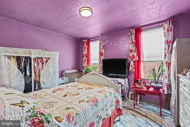 2824 Ashland Ave, Baltimore, MD 21205 - carpeted bedroom with radiator heating unit and a textured ceiling