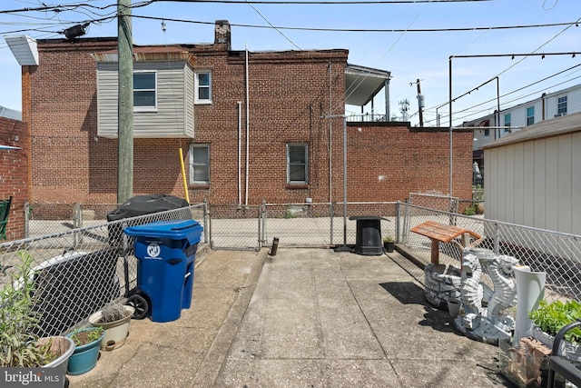 2824 Ashland Ave, Baltimore, MD 21205 - rear view of property featuring brick siding and a gate